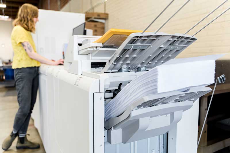 YellowDog employee operates a digital press.